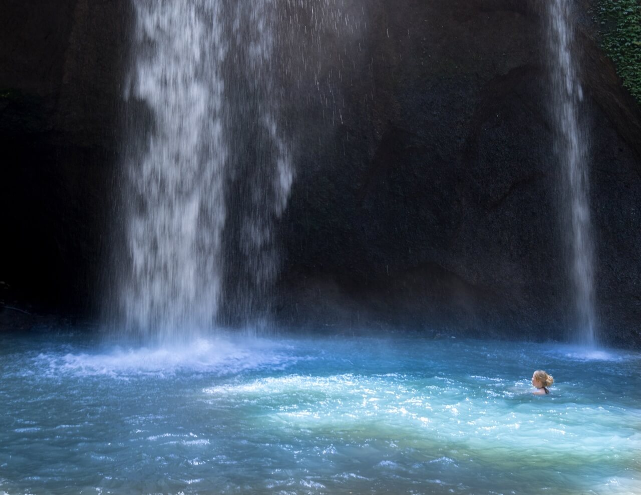 Swimming around the Tukad Cepung waterfall in Ubud, Bali - Indonesia