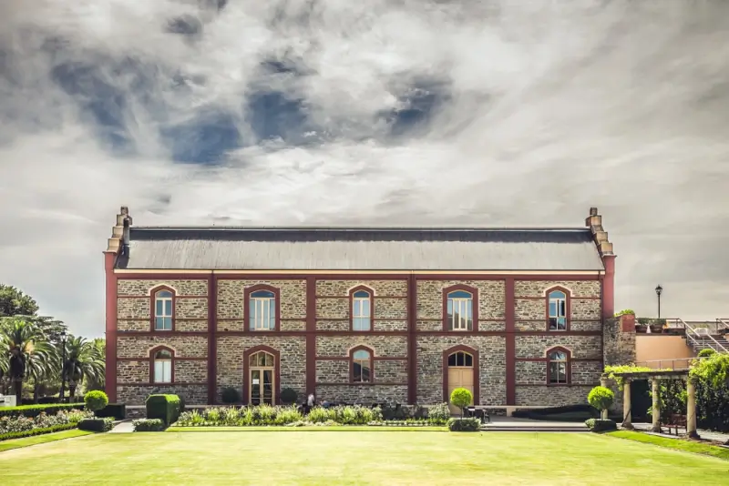 Historic stone building in Angaston South Australia with manicured gardens and lawn in Barossa Valley