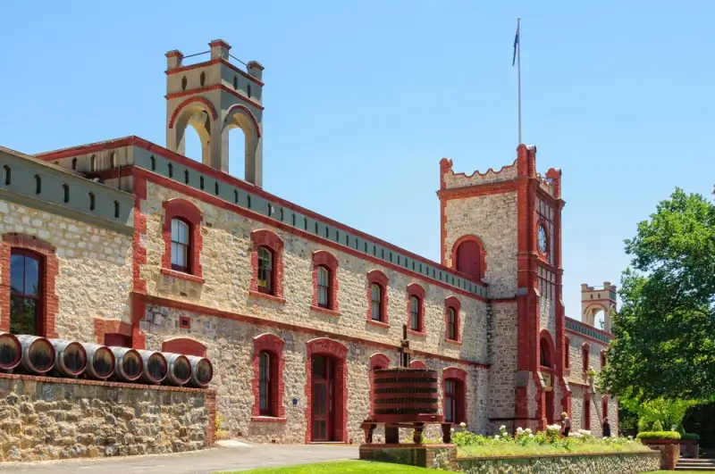 Historic stone winery building with clock tower and wine barrels in Barossa Valley near Angaston South Australia