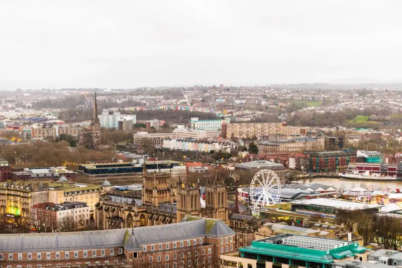 Aerial view of Bristol city center with harbor and ferris wheel, affordable UK holiday destination