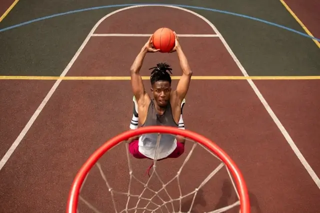 Player preparing to shoot on outdoor urban basketball court with colorful street markings