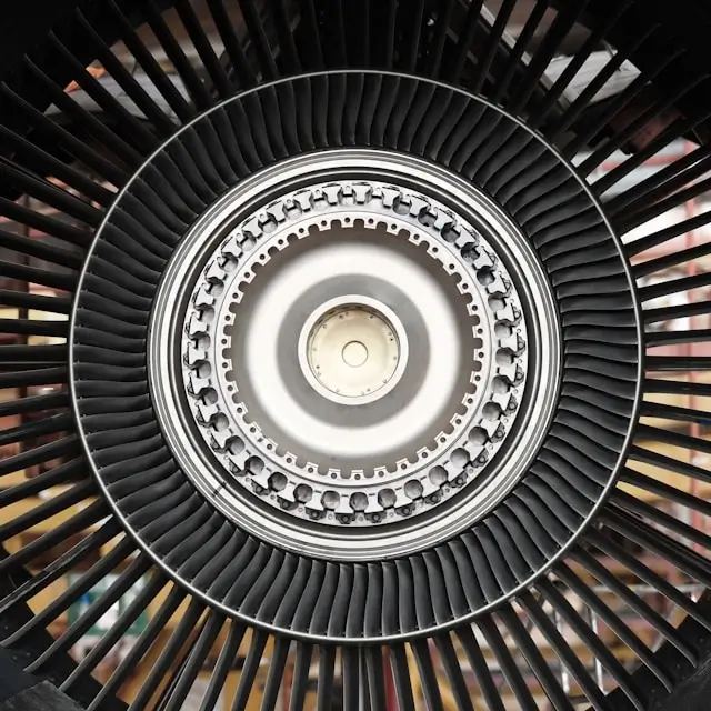 Close-up view of aircraft jet engine turbine blades and internal components requiring regular maintenance inspection