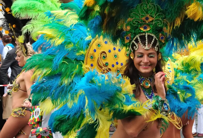 Brazilian samba dancers in vibrant feathered costumes celebrating Carnival with bold expressions and festive energy