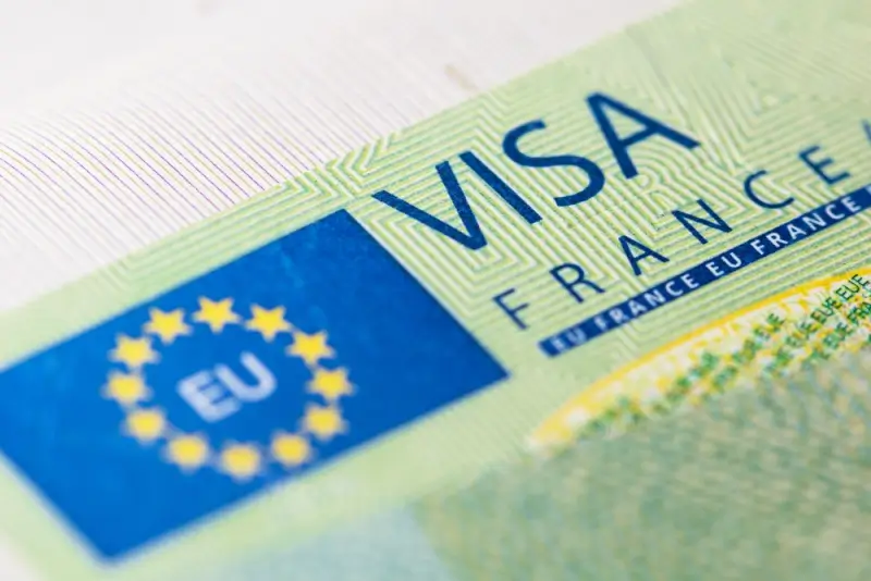 Close-up of French Schengen visa sticker with EU flag and holographic security features