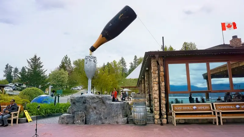 Summerhill Pyramid Winery entrance featuring iconic oversized wine bottle sculpture in Kelowna's vineyard region