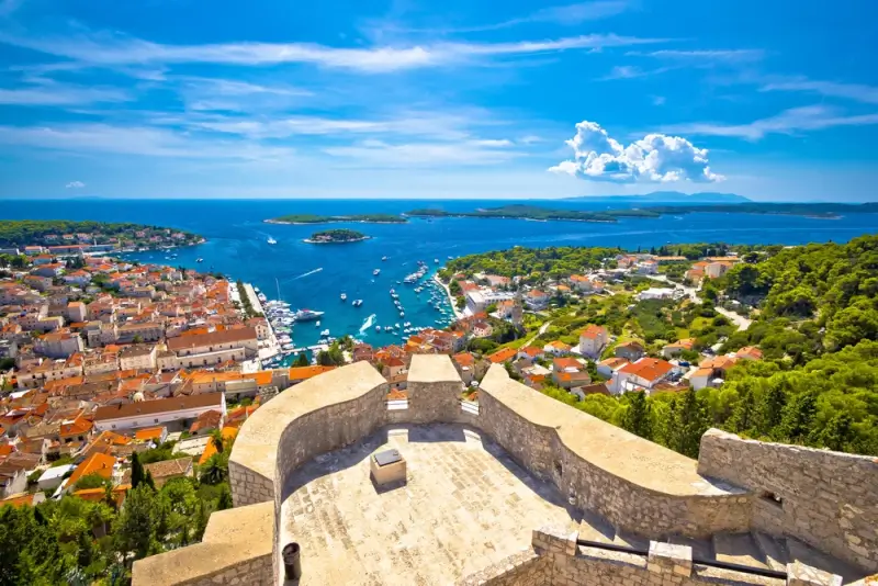 Panoramic view from Fortica fortress overlooking Hvar Town, marina, Pakleni Islands, and Adriatic Sea from hilltop ramparts