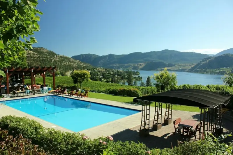 Luxury lakefront resort pool with panoramic Okanagan Lake views perfect for Kelowna vacation accommodations