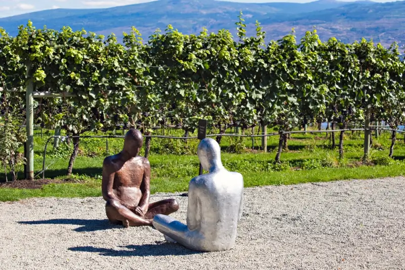 Contemporary sculptures displayed among lush vineyard rows showcasing art and wine culture in Kelowna BC