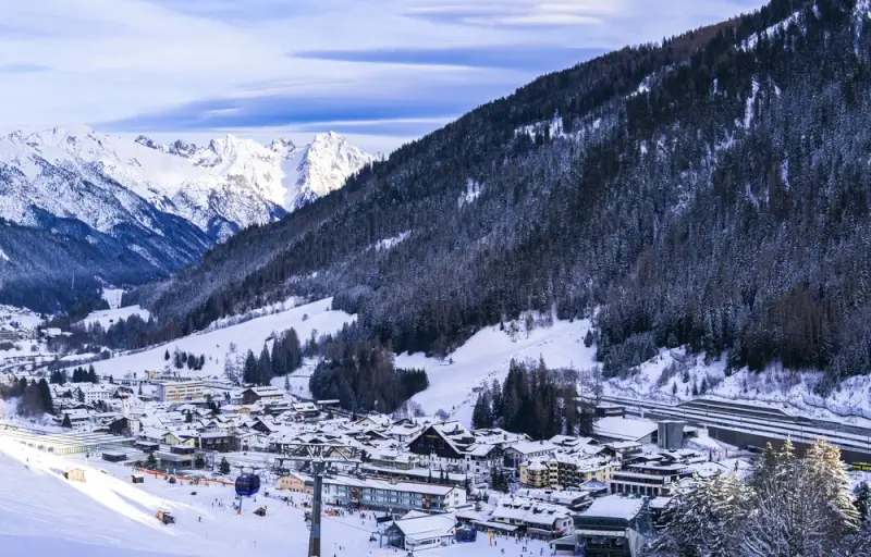 St. Anton am Arlberg village nestled in snow-covered valley marking the western terminus of the Adlerweg long-distance hiking route