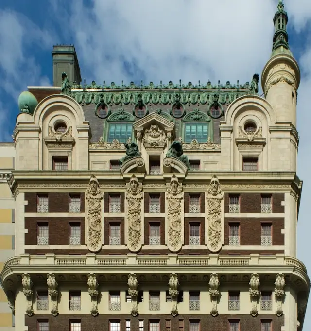 Historic Adolphus Hotel penthouse exterior showcasing ornate Beaux-Arts architecture with decorative stonework and green copper roofing in Dallas, TX