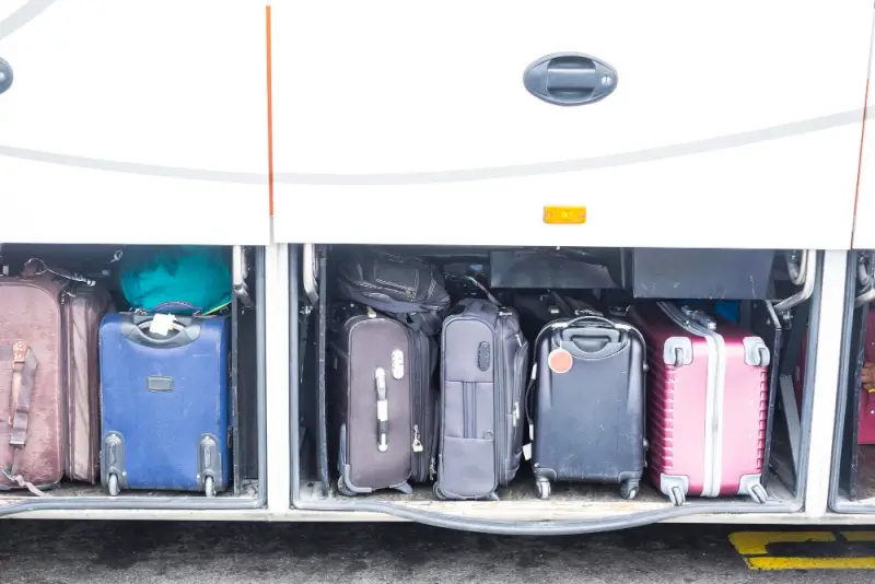 Affordable luggage storage in Melbourne with suitcases secured in bus compartment