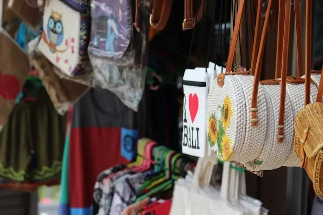 Colorful souvenir bags, clothing, and I Love Bali merchandise at local market shop in Indonesia