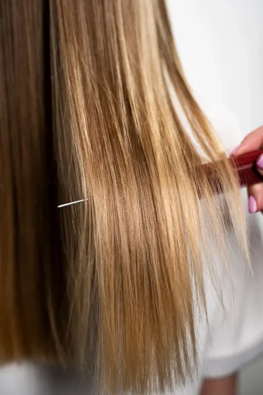 Smooth shiny blonde hair after keratin treatment showing frizz-free results
