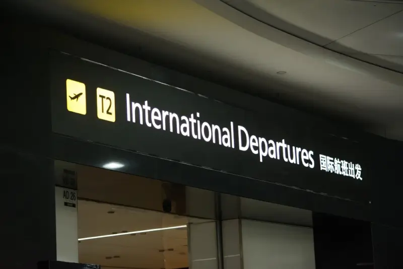 International Departures terminal sign at Melbourne Airport with luggage storage facilities nearby