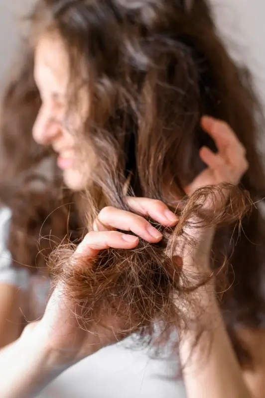 Woman with extremely frizzy tangled hair that needs keratin treatment for smoothing