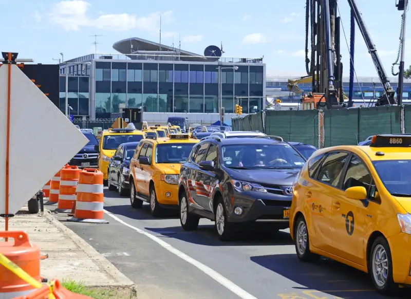 Yellow taxis and vehicles navigating LaGuardia construction traffic during airport redevelopment