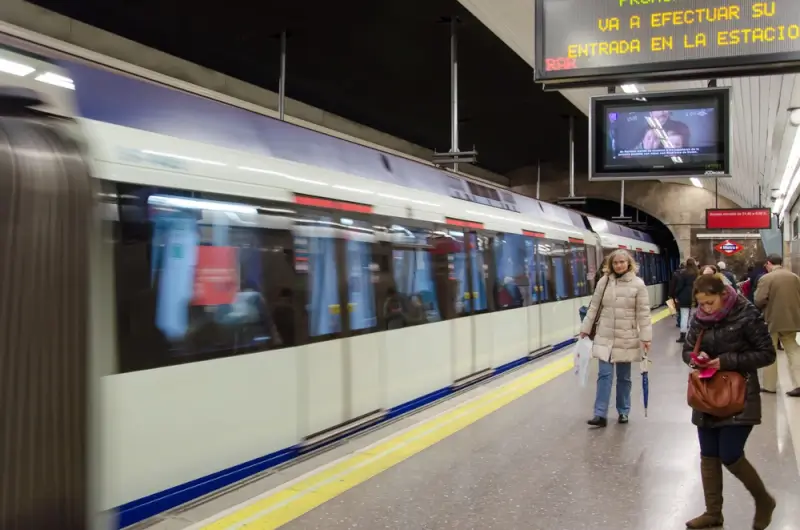 Madrid Metro station platform with arriving train, part of Spain's efficient public transport system