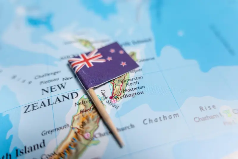 New Zealand flag pin placed on map showing Wellington and major cities for migration planning