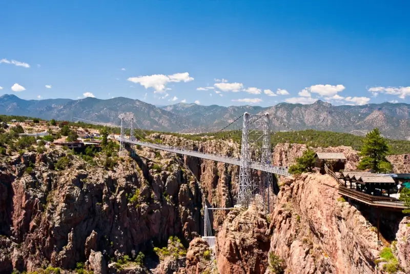 Royal Gorge suspension bridge spanning deep canyon with Arkansas River below in Colorado mountains