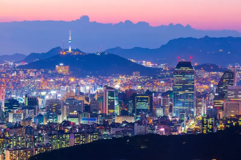 Seoul city skyline at dusk with N Seoul Tower and mountains during first trip to South Korea