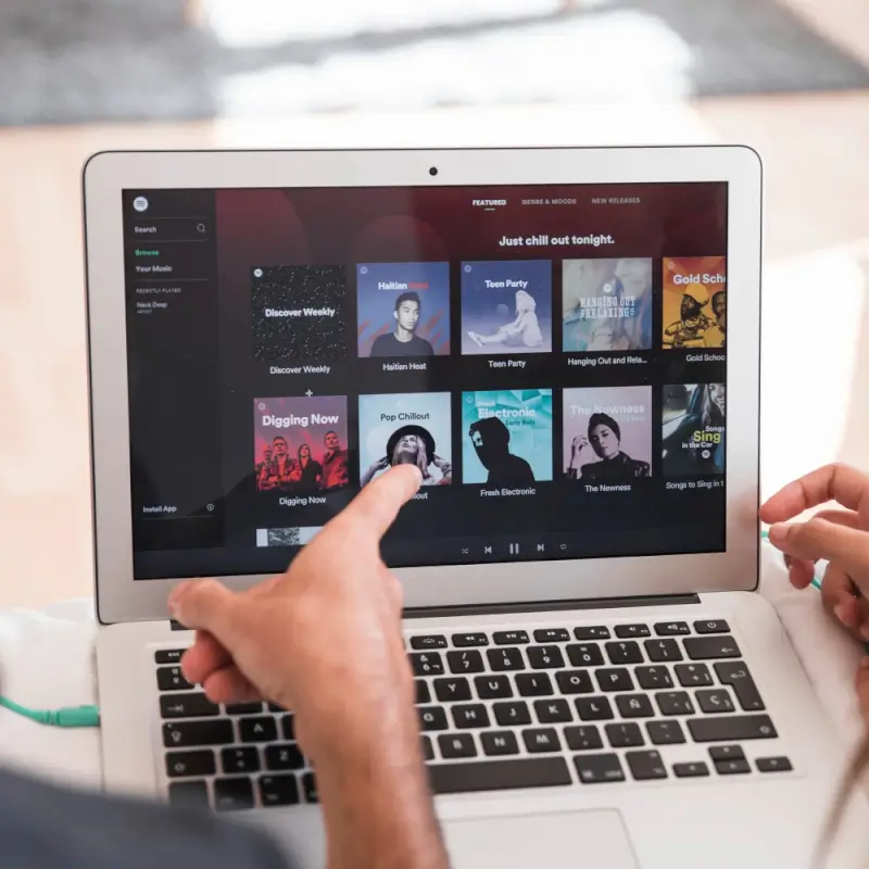Music streaming subscription on laptop screen showing playlists for ongoing entertainment gift that delivers year-round value