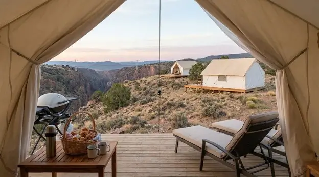Canvas tent deck with lounge chairs and gorge views at Colorado luxury camping retreat