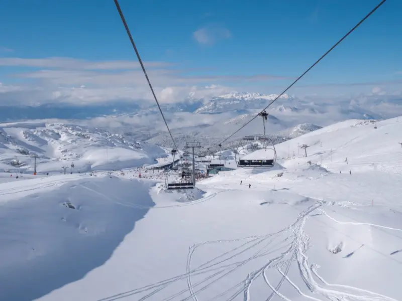Chairlift ride at Parnassos Ski Center offering panoramic views of snow-covered Greek mountain peaks