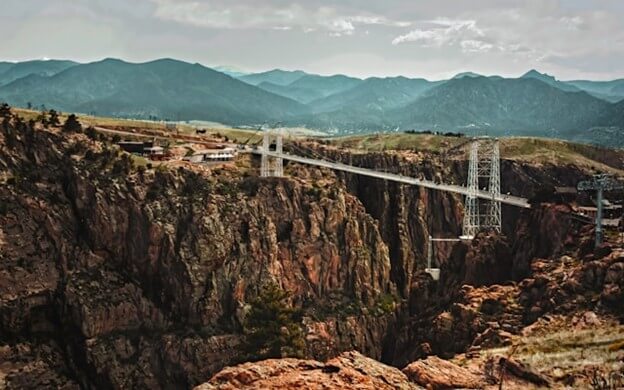 Royal Gorge Bridge spanning deep canyon with mountain ranges in background near Arkansas River fishing areas