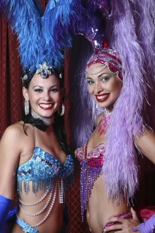 Cabaret dancers in feathered costumes and jeweled headdresses at Tropicana nightclub show