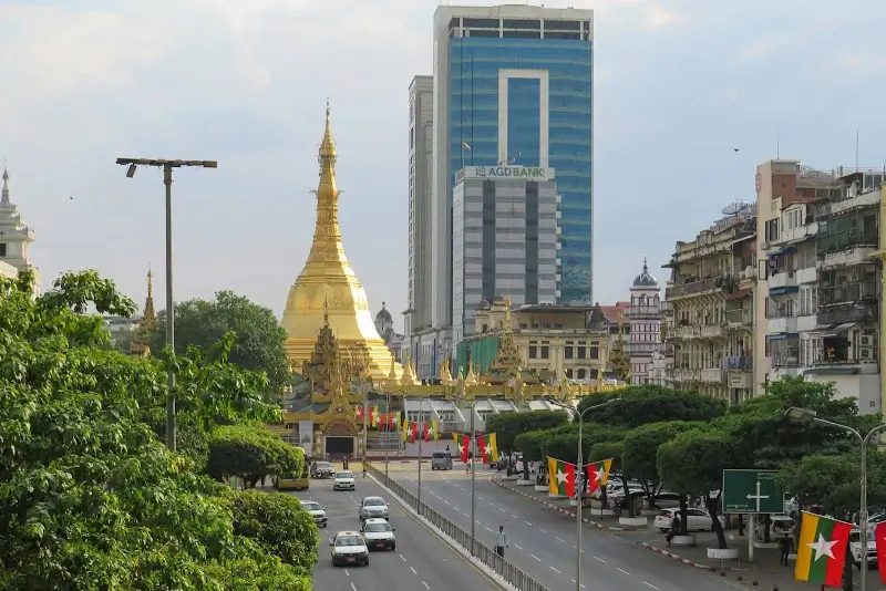 Sule Pagoda surrounded by busy streets and modern buildings in downtown Yangon, Myanmar