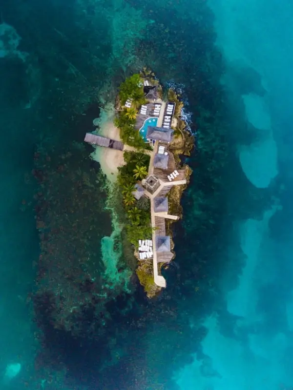 Aerial view of a small private island resort surrounded by turquoise Caribbean waters in Jamaica