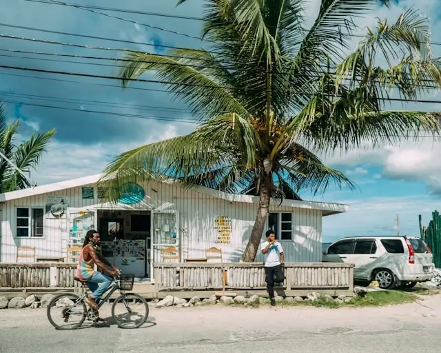 Local street scene with people and a small shop in Negril, Jamaica