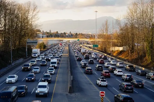 Heavy traffic on Vancouver highway during rush hour with mountain backdrop