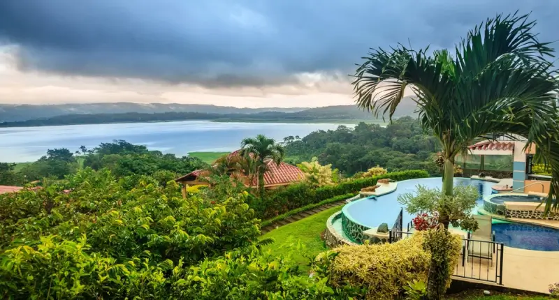 Scenic view of Lake Arenal from luxury villa with infinity pool surrounded by lush tropical gardens in Costa Rica