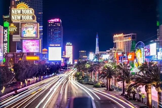 Las Vegas Strip at night with traffic light trails and illuminated casino resorts