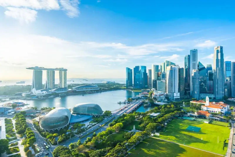 Aerial view of Singapore's skyline featuring Marina Bay Sands, the Esplanade, and the city's financial district on a clear day