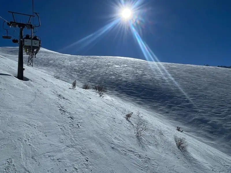 Brezovica ski slopes with chairlift and sun flare in Šar Mountains, Kosovo