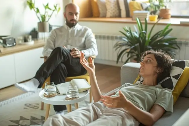woman reclining on a chair talking to her therapist during a dual diagnosis consultation