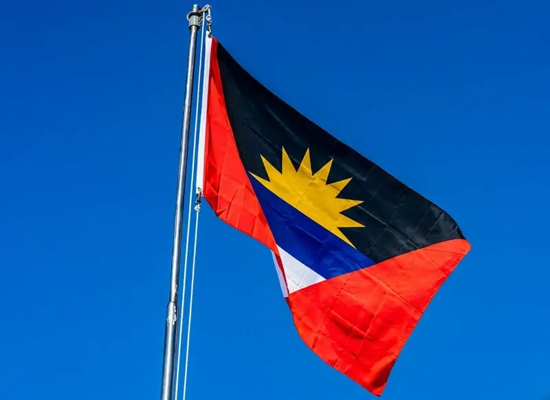 National flag of Antigua Barbuda flying high on a sunny day