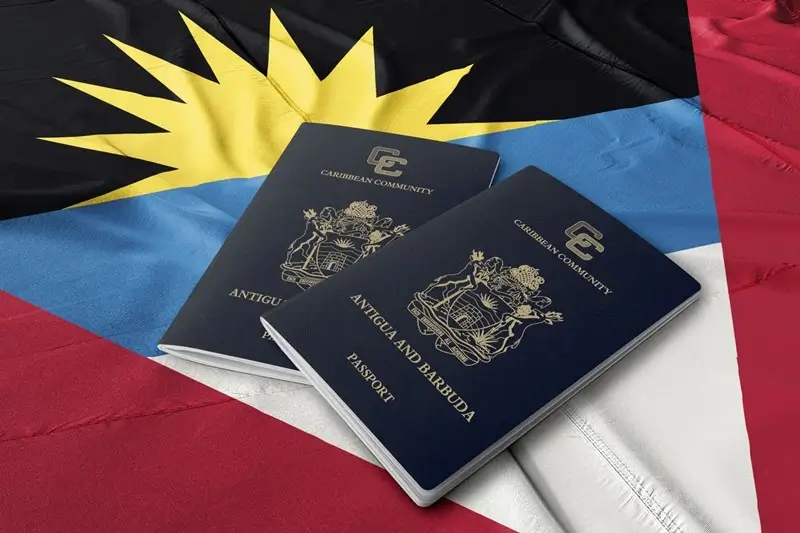 Official Antigua passports on a Barbuda flag background