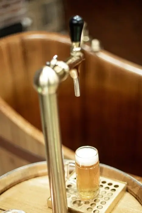 Beer tap and wooden soaking tub at a beer spa in Prague, Czechia