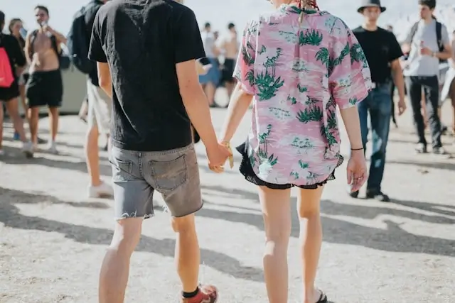 couple holding hands at an outdoor festival in summer