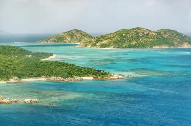 aerial view of Lizard Island with lush green hills and turquoise reef waters in Queensland Australia