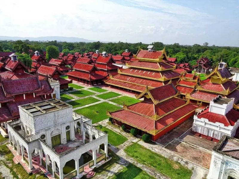 Aerial view of Mandalay Palace with red and gold rooftops, one of the historic sites in Myanmar.