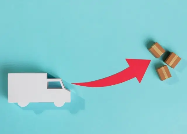 white moving truck illustration with a red arrow pointing to small boxes on a blue background