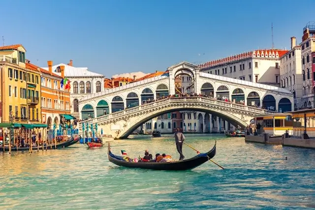 Venice Grand Canal with gondola and Rialto Bridge near St. Regis hotel