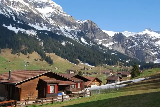 Traditional Swiss chalets in Adelboden with dramatic mountain backdrop near The Cambrian hotel
