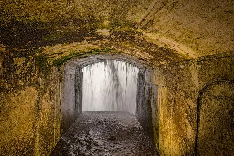 bedrock tunnel portal looking out through the curtain of water at journey behind the falls in Ontario