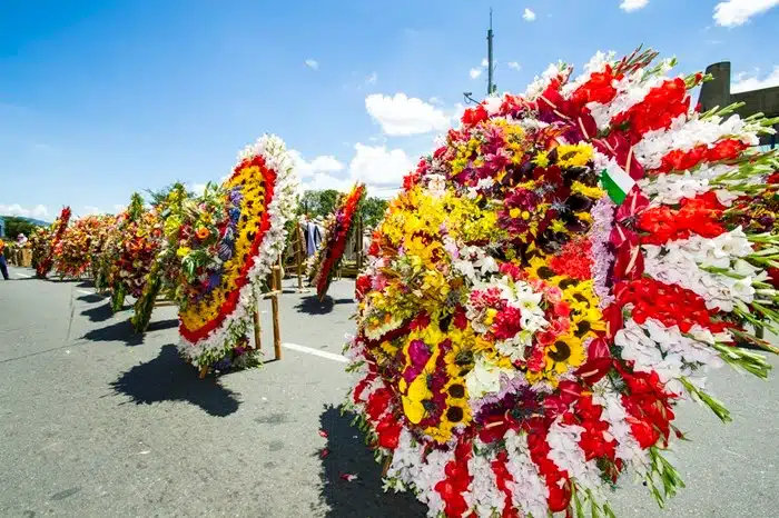 Large colorful silleta floral arrangements displayed on a sunny street during the Feria de las Flores in Medellín, Colombia