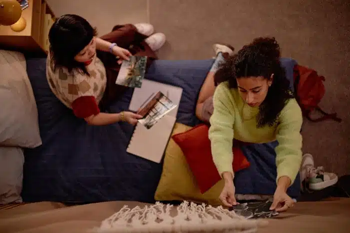 two women doing a scavenger hunt at home indoors